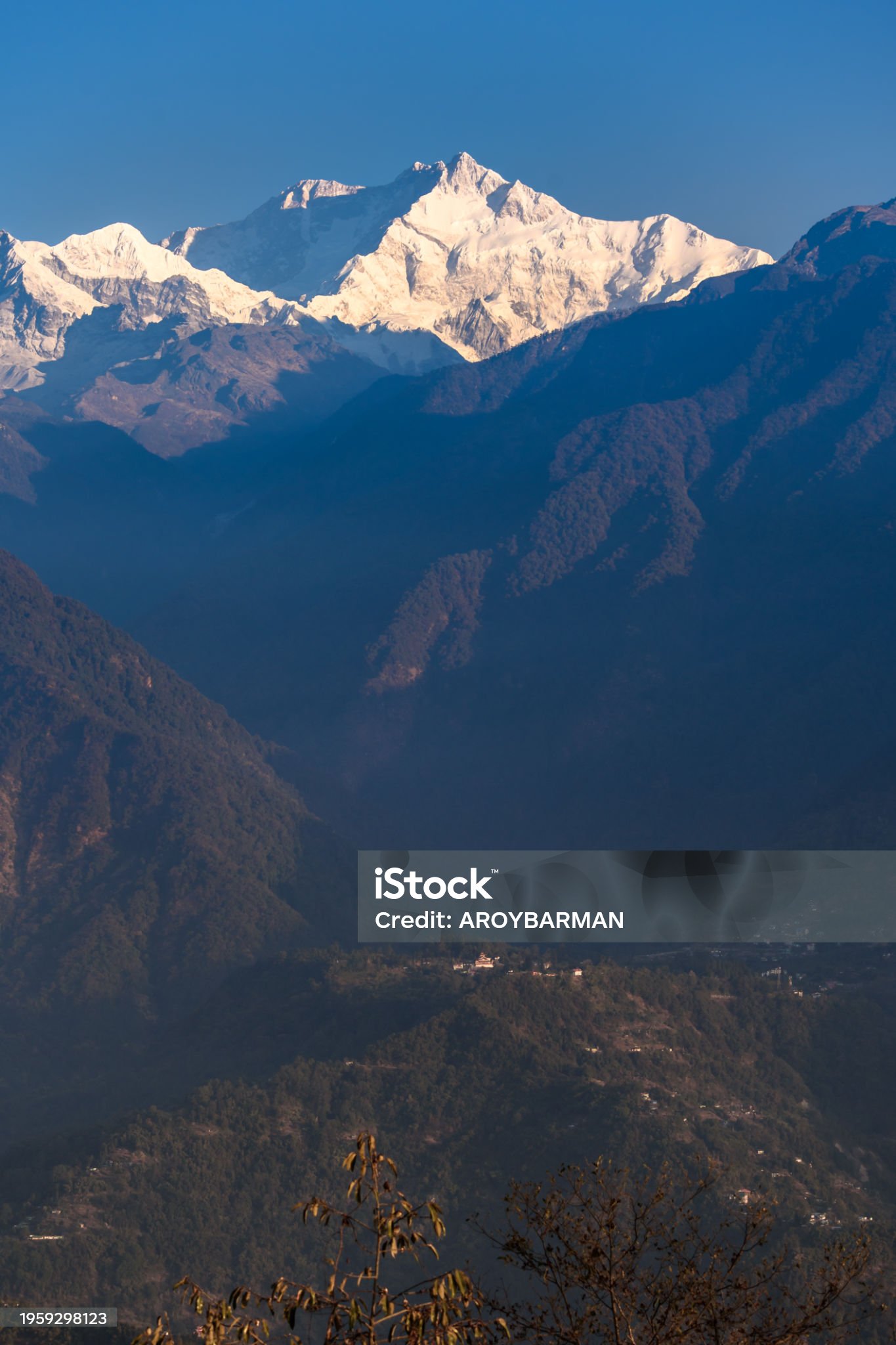 Portrait view of Snow clad Kangchenjunga, also spelled Kanchenjunga, with Mountain Layers.
